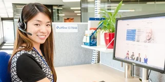 Woman smiles at camera while at desk photo max 800x600