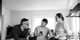 Teen vaping family kitchen bench