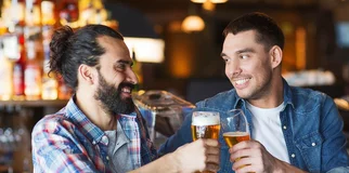 Two friends cheers holding beers width 960