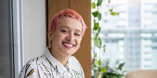 Woman pink hair smiling