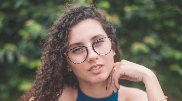 Young woman with glasses looking in camera