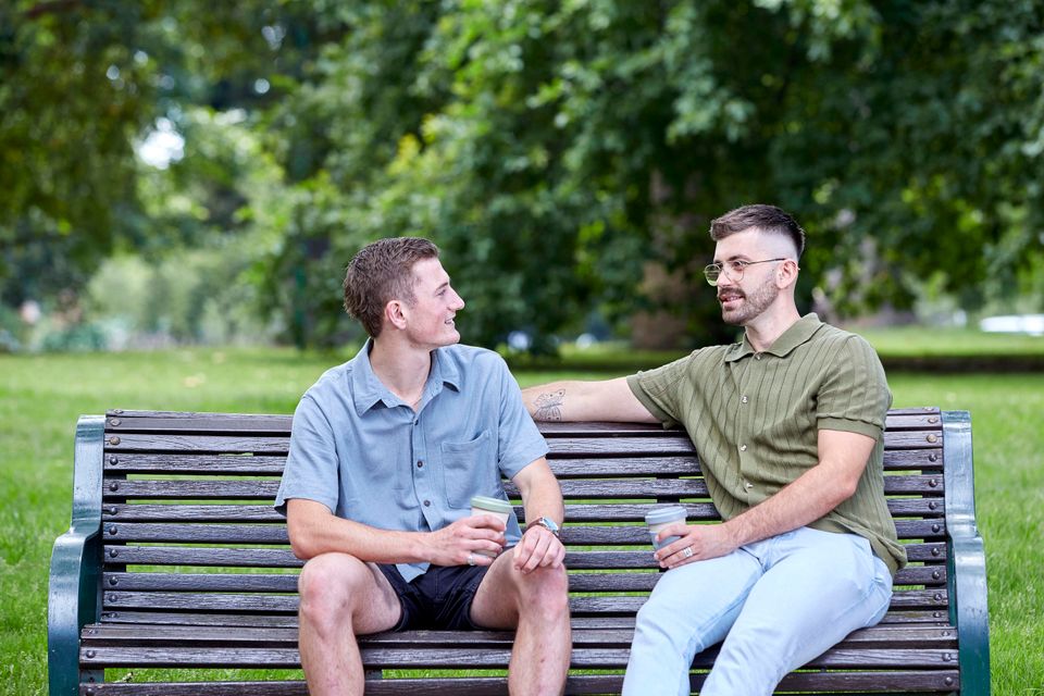 two boys sitting on park bench
