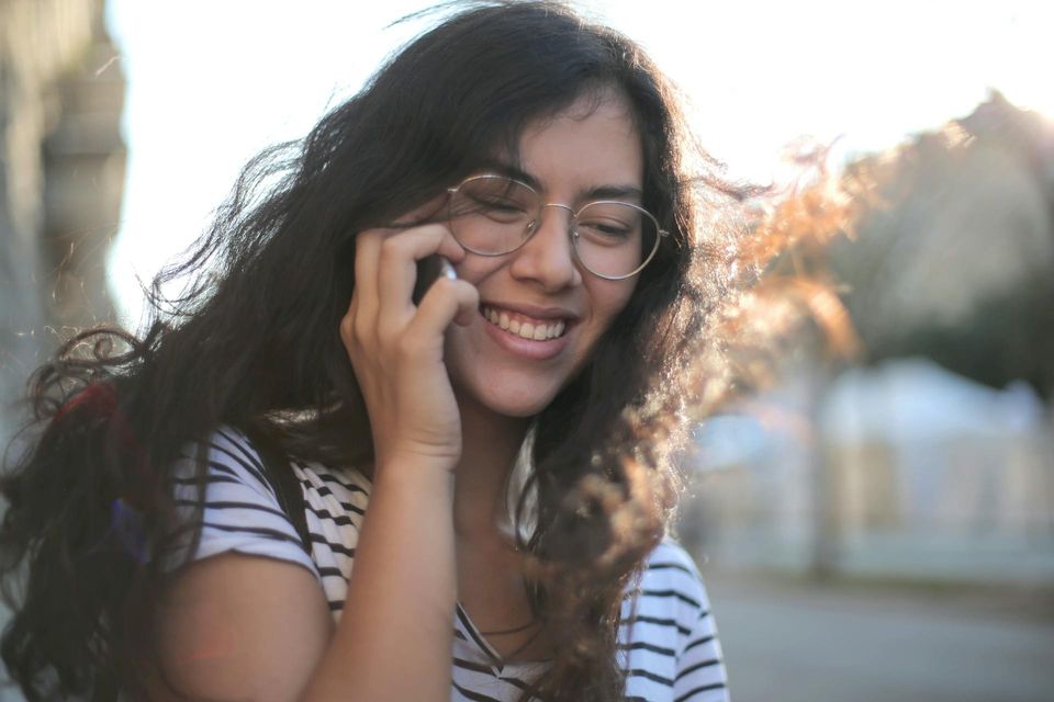 Young person on phone smiling