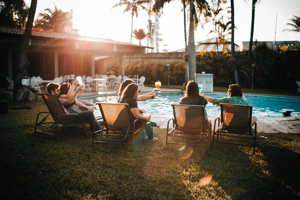 People sitting by the pool social gathering